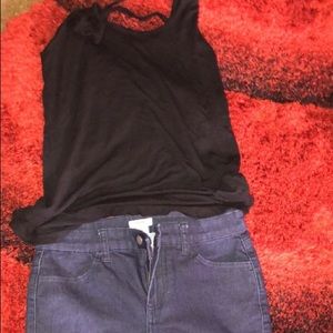 BLACK SLEEVELESS SHIRT & BLUE PANTS .